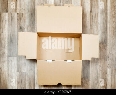 Opened box on the floor Stock Photo