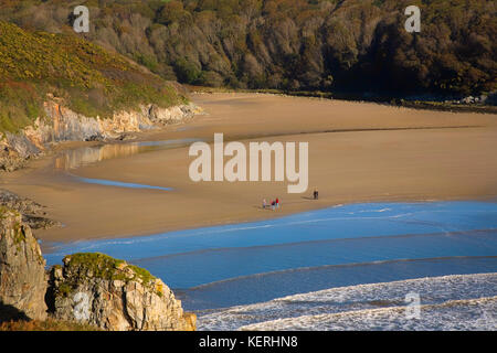 Walkers on Stradbally Cove, The Copper Coast, County Waterford, Ireland Stock Photo