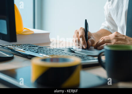 Interior design professional working on graphic tablet sketch pad in architecture studio office