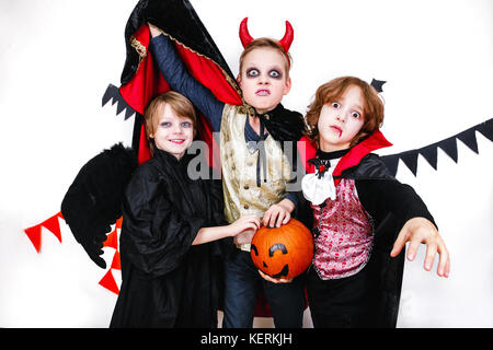 Children in halloween costumes show funny faces Stock Photo