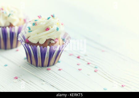 Festive cupcakes with burning candles Stock Photo