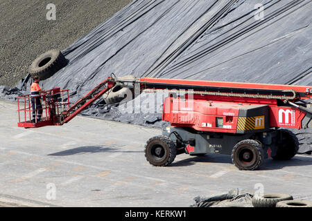 Worker on a Haulotte platform and telehandler in Malaga spain Stock Photo