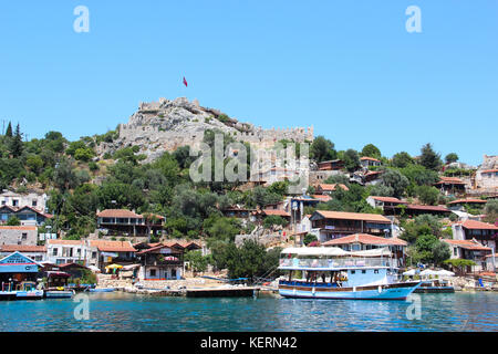 Coast of the island in the Mediterranean sea, modern picturesque village with the ruins of ancient Lycian towns and tombs-sarcophagi of Aperlai Stock Photo