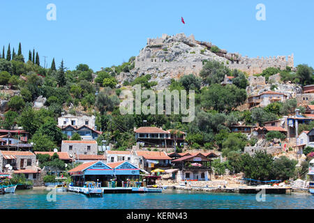 Coast of the island in the Mediterranean sea, modern picturesque village with the ruins of ancient Lycian towns and tombs-sarcophagi  Aperlai, kekova Stock Photo