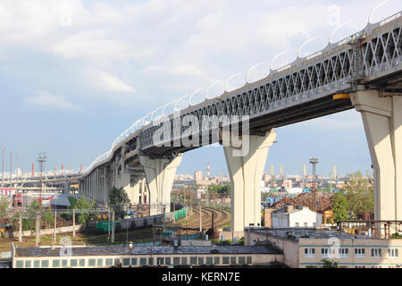 Bridge over industrial area trade port with railway wagons with cranes and navigable channel of the Western high-speed diameter, a toll motorway Stock Photo