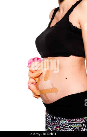 detail of pregnant belly with female doll Stock Photo