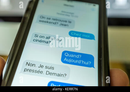 Text messages written in French on a smartphone Stock Photo