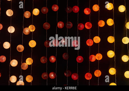 Red, orange and yellow cotton ball string lights for patio, wedding, party and decoration Stock Photo