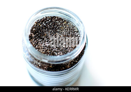 Chia seeds in a glass jar, top view, close-up. Stock Photo