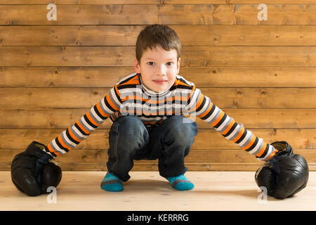 boy in boxing gloves playing indoors Stock Photo