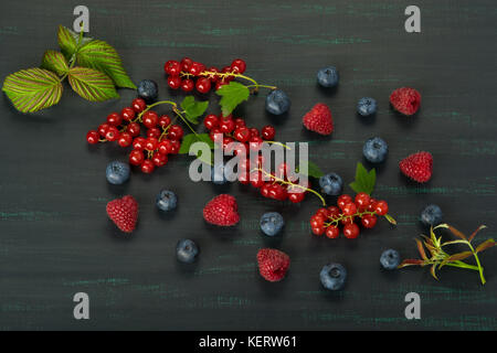 Summer berries with leaves on a dark background close-up Stock Photo