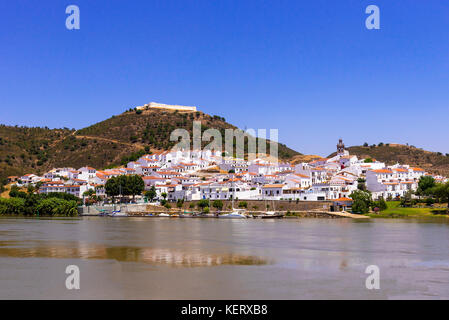 Small Spanish town of Sanlúcar de Guadiana from across the Guadiana river in Alcoutim Portugal Stock Photo