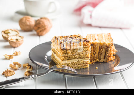 Cake with walnuts and honey on plate. Stock Photo