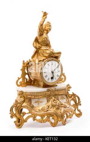 Antique gold colored table clock on the white background. Stock Photo