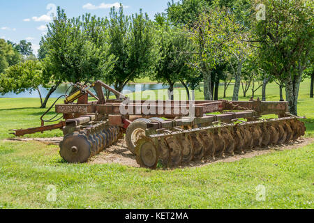 Old farm disc harrow equipment for tilling soil Stock Photo