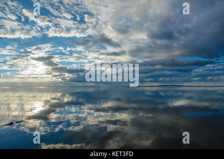 Blast In the evening sky Reflected with a large surface.The sunset reflects beautifully on the surface of the water. in the monsoon season Stock Photo