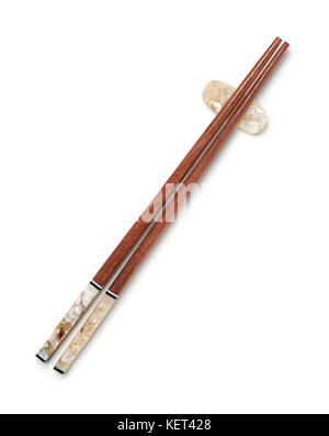Top view of wooden chopsticks on chopstick rest isolated on white Stock Photo