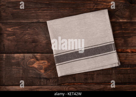 Top view of linen napkin on dark wooden table Stock Photo