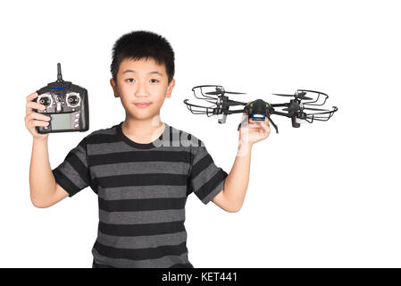 Asian boy holding hexacopter drone and radio remote control (controlling handset) for helicopter, drone or plane, studio shot isolated on white backgr Stock Photo