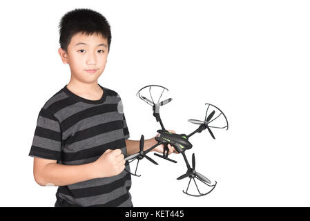 Successful happy and attractive Asian boy holding hexacopter drone and punching the air with his fist, isolated on white background. Stock Photo