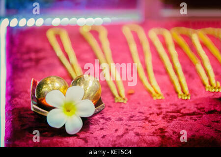 egg and necklace gold with flower on red background Stock Photo