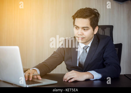 Asian businessmen using notebook and fill serious about the work done until the headache Stock Photo