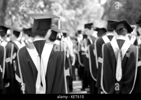 blurry of Graduates are walking the line to get a diploma and selective focus. Stock Photo