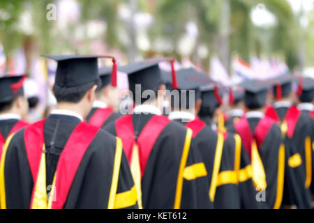 blurry of Graduates are walking the line to get a diploma and selective focus. Stock Photo