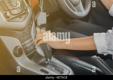Woman's hand is about to drive into gear ,selective focus on hand Stock Photo