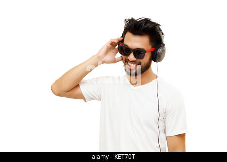 Asian handsome man with a mustache, smiling and laughing listen music with headphones isolated on white background Stock Photo