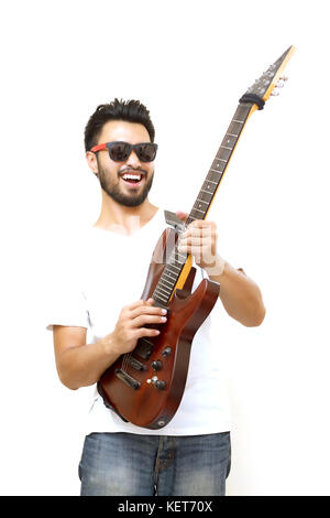 Asian handsome man with a mustache, smiling and laughing and playing guitar and listen music with headphones ,Blurry and soft focus Stock Photo