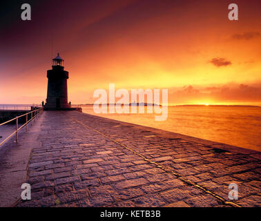 Channel Islands. Guernsey. Saint Peter Port. Castle breakwater and lighthouse at sunrise. Stock Photo