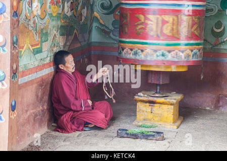 A buddhist monk prays during a sacred ritual in the monastery of Thimphu Wangdue Bhutan Asia Stock Photo
