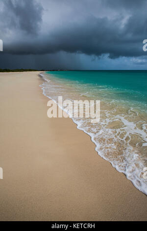 Storm clouds on fine sand framed by the turquoise sea Pink Sand Beach Antigua and Barbuda Leeward Islands West Indies Stock Photo