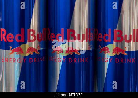 Cans of energy drink Red Bull on display on a supermarket store shelf. Stock Photo