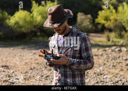 A man flying a Mavic Pro drone in beautiful nature Stock Photo