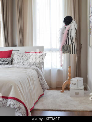 stylish bedroom interior with flower pattern pillows Stock Photo
