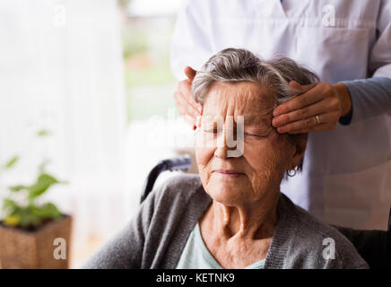 Health visitor and a senior woman during home visit. Stock Photo