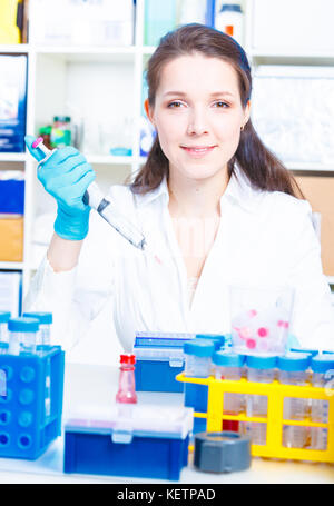 Female technician doing science experiment Stock Photo