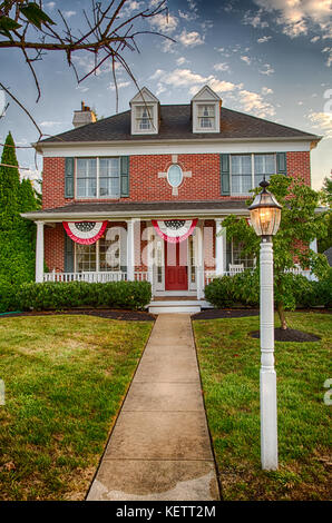 A colonial house in Medford, New Jersey with American Flag buntings on the porch. Stock Photo