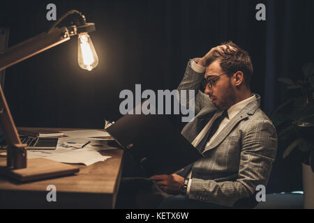 overworked businessman with paperwork  Stock Photo