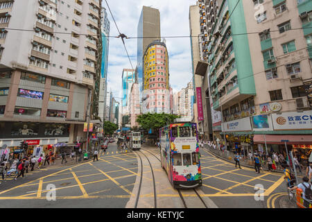 Double-decker tram on street of HK. Hong Kong Tramways is a tram system in Hong Kong, being one of the earliest forms of public transport in the metro Stock Photo