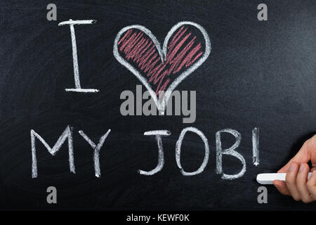 A Person Hand Showing Job Loving Concept Written On Blackboard Stock Photo