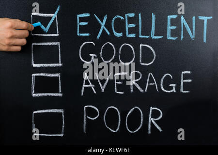 Close-up Of Performance Evaluation Showing Excellent Remark On Blackboard Stock Photo