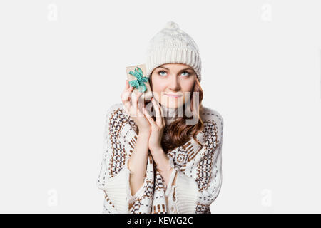 Gorgeous woman holding tiny present, curiosity xmas concept Stock Photo