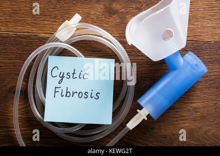 Cystic Fibrosis Concept With Inhaler Mask On Wooden Desk Stock Photo