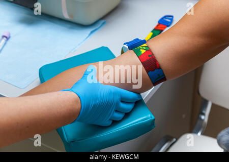 the doctor takes blood from the vein on the arm Stock Photo