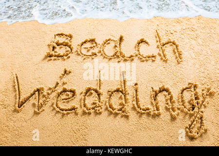 High Angle View Of A Beach Wedding Message Written On Sand Stock Photo