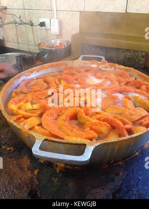 Large saucepan of pumpkin sweet being made on wood burning stove Stock Photo