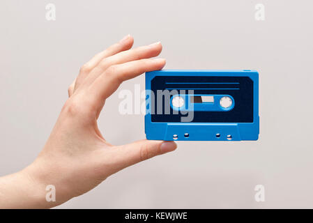 hand holding blue cassette tape Stock Photo